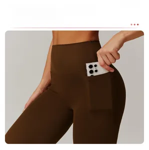 Detail of high-waisted yoga pants with side pockets for smartphones in chocolate brown