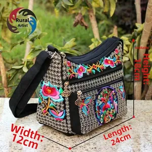 Ethnic style black canvas crossbody bag with colorful flower embroidery and zipper details