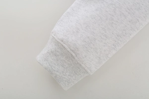 Detail of light gray ribbed knit cuffs with fine marl texture and high elasticity