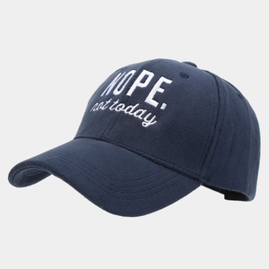 Close-up of 'NOPE. not today' embroidery on soft navy blue winter baseball cap
