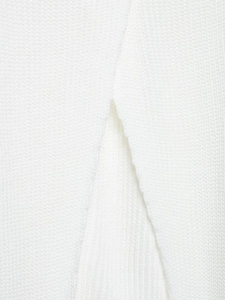 Detail shot of the back split design and rib knit texture on the white turtleneck sweater