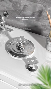 Macro detail of silver flower toilet button with mirror finish and petal design