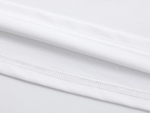 Close-up of precision double-needle stitching on white off-shoulder knitted T-shirt hem