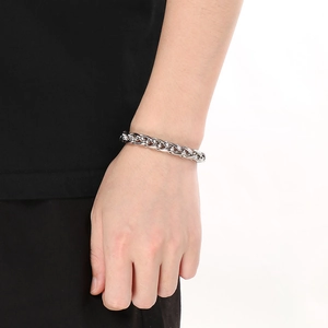 Close-up of a silver stainless steel basket chain bracelet worn on a wrist with side view