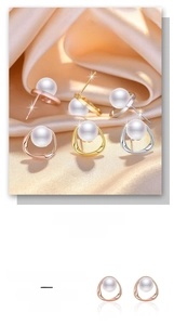 Close-up of elegant gold and silver pearl earrings on a luxurious silk satin background