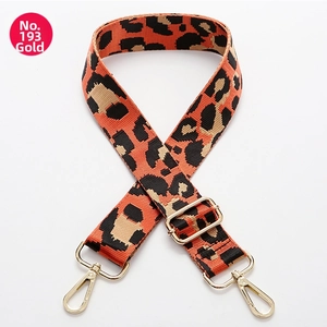 Detailed view of leopard print bag strap with golden metal swivel hooks and adjuster