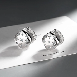 Macro shot of silver square stud earrings with nine star-shaped cubic zirconia stones