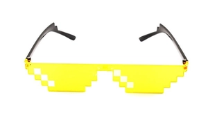 Detail of creative pixel style party sunglasses featuring transparent yellow lenses