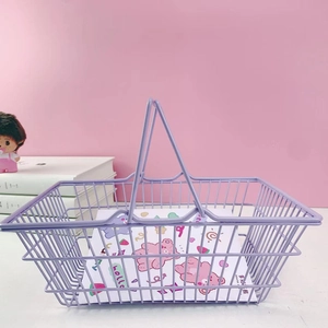 Purple wire storage basket with dual handles shown against a soft pink desktop background