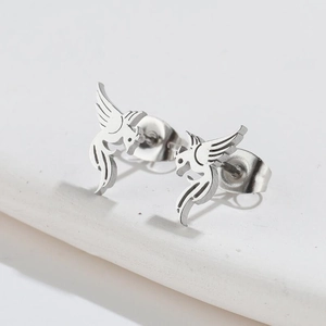 Detail of minimalist silver phoenix bird earrings in a 18K gold plated hollow design