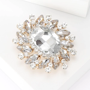 Macro shot of sparkling oval crystal brooch with teardrop rhinestones on white base