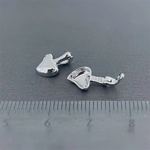 Macro shot of S925 sterling silver heart pendant connector with hinge and hallmark