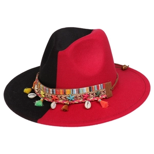Detail of red and black felt fedora with colorful woven band, tassels, and shell accents