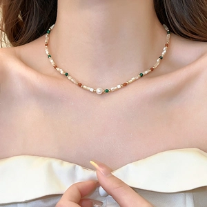 Close-up of bohemian beaded necklace with natural baroque pearl and shiny star filter effect