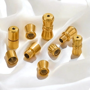 Golden stainless steel screw clasp connectors for jewelry necklaces on white silk fabric
