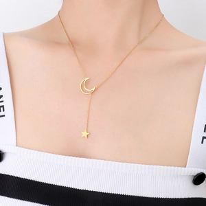 Minimalist gold Y-shaped necklace featuring star and moon pendants on a female model