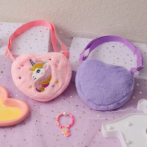 Detail view of heart-shaped plush unicorn shoulder bags with matching beaded bracelets