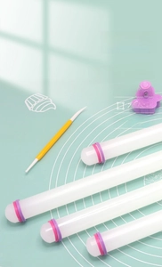 Detail of 9-inch PP rolling pins with purple and pink thickness adjustment rings on a mat