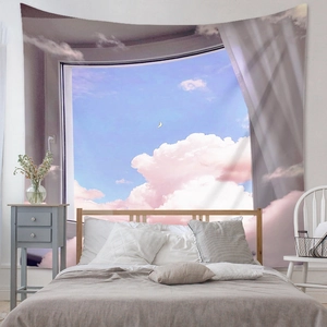 Detail of dreamlike tapestry showing pink clouds and crescent moon in a bedroom setting