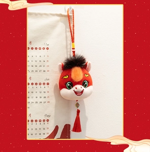 Detail view of a 2026 Year of the Horse mascot plush hanging ornament with red tassel