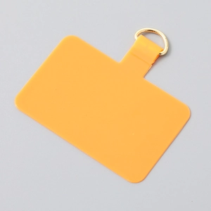 Detailed view of yellow TPU phone lanyard tab with a durable golden metal D-ring attachment