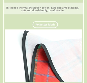 Detail of insulated polyester oven mitt with red plaid front and waffle texture