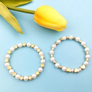 Handmade DIY jewelry set featuring pearl bracelets with gold star and heart charms