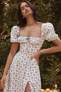 Detail of puff sleeves and lace-up square neckline on floral split maxi dress