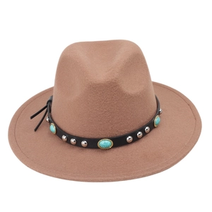 Detail of western fedora hat with turquoise stones and silver studs on black leather band
