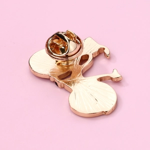 Minimalist golden bicycle alloy brooch showing metal texture and butterfly clutch back