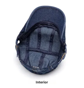 Internal view of blue denim flat cap showing reinforcement tapes and metal buckles