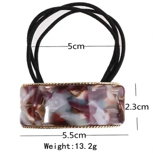 Square acetate hair tie with marble pattern resin and golden metal frame detail