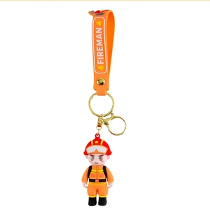 Close-up of orange fireman figure keychain with FIREMAN embossed silicone wrist strap