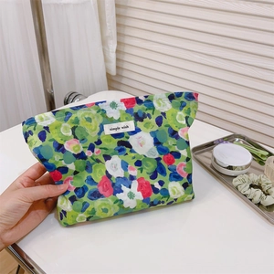 Floral cotton toiletry bag with green botanical patterns and a simple wish label