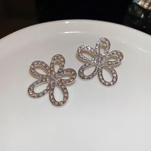 Sparkling S925 silver hollow flower stud earrings with pavé zircons for a luxury look