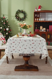 Detailed embroidery of red berries and green pine branches on a festive cotton tablecloth