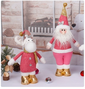 Detailed view of plush Santa and Reindeer dolls with pink fabric and golden sequins