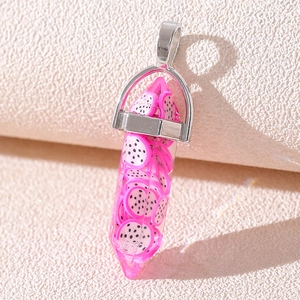 Macro shot of a crystal pillar pendant featuring pink dragon fruit slices and silver clasp