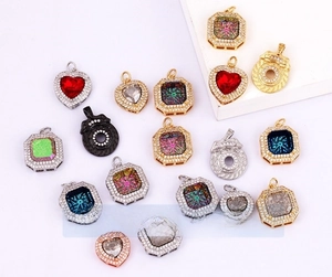 Detailed macro view of gold-plated snowflake and star charms with colorful zircon stones