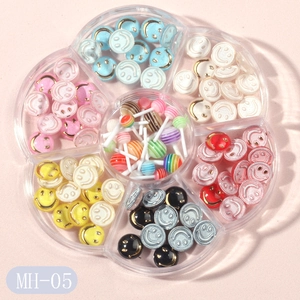 Flower-shaped organizer with colorful smile buttons and mini lollipop nail art charms