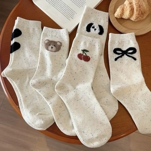 Cute college style cotton mid-calf socks with various animal embroidery on a wooden table