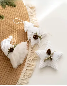 Detail of Nordic Christmas ornaments with waffle texture and mini pine cones on fringe mat