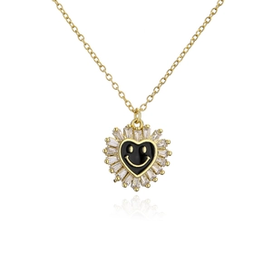 Detailed view of heart pendant necklace with black enamel smiley face and zircon frame