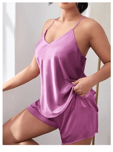 Close-up of luxury satin two-piece sleepwear set with silk texture and V-neckline detail