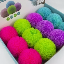 Close-up of colorful LED puffer balls in a display box for stress relief