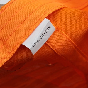 Detail of 100% cotton fabric and premium stitching on orange embroidered baseball cap