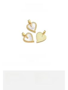 Detailed view of heart-shaped shell pendant with 18k gold plating and small pearls
