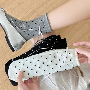 Detailed view of polka dot mid-calf socks with ribbons and ruffled edges in three colors