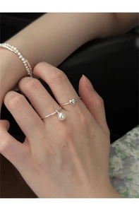 Detail of 925 sterling silver heart ring and pearl pendant jewelry set worn by model