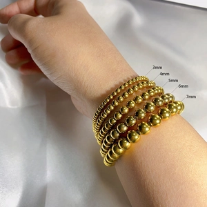 Detail of five sizes of gold stainless steel bead bracelets with sizes 3mm to 7mm